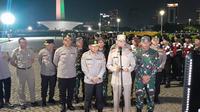 Penjabat Gubernur DKI Jakarta Heru Budi Hartono, Kapolda Metro Jaya Irjen Karyoto dan Kodam Jaya TNI Mayjen Muhammad Hassan saat apel di kawasan Monas, Jakarta Pusat, Sabtu malam (13/5/2023). (Foto: Liputan6.com/Ady Anugrahadi)