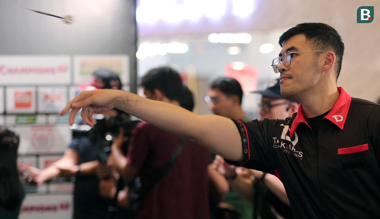 Sunny Kings Handoko melemparkan anak panah saat berkompetisi dalam ajang Darts National Competition 2024 series 4 di Baywalk Mall, Jakarta Utara, Minggu (18/08/2024). (Bola.com/Agri Aulian Perdana)
