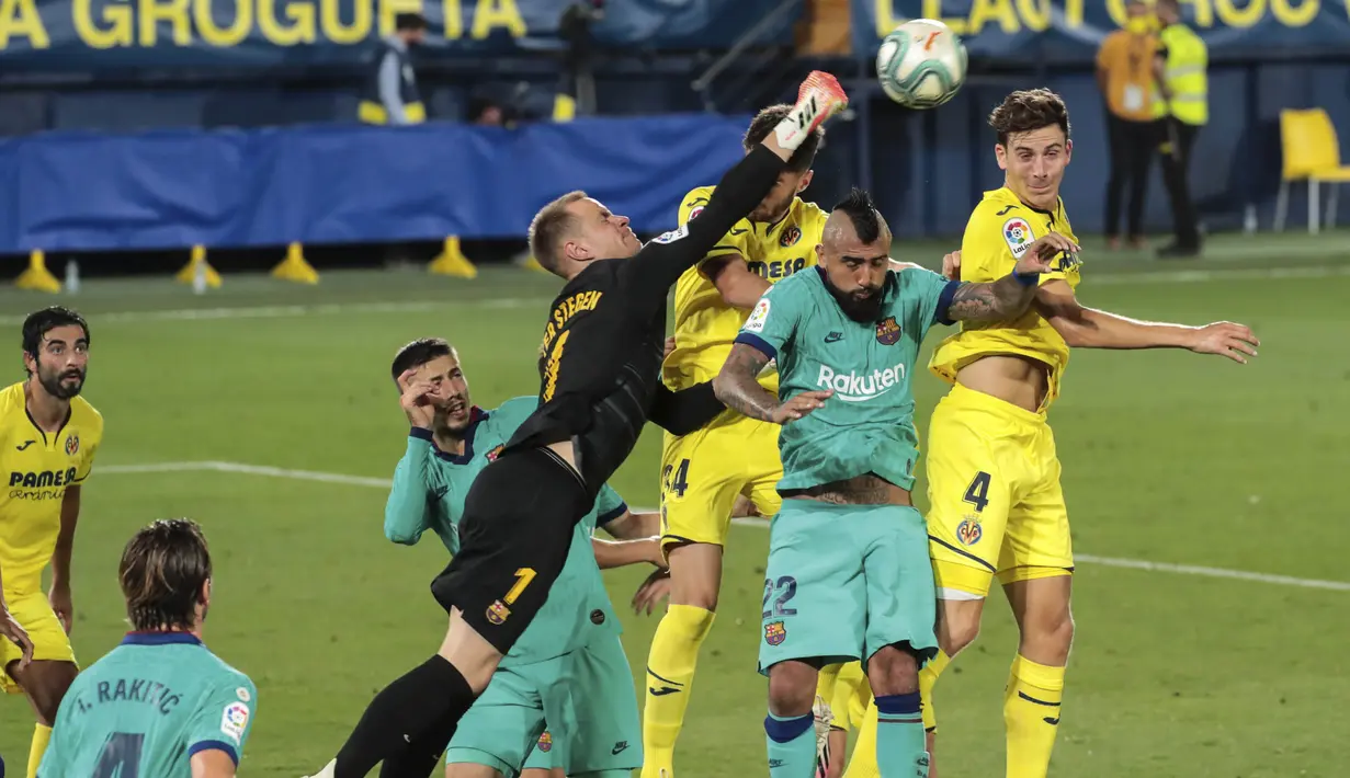 Kiper Barcelona, Marc-Andre ter Stegen, menghalau bola saat melawan Villareal pada laga La Liga di Stadion Estadio de la Ceramica, Minggu (5/7/2020). Barcelona menang 4-1 atas Villareal. (AFP/Jose Jordan)