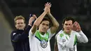 Para pemain  Wolfsburg, Andre Schuerrle, Max Kruse  memberikan sala kepada suporter usai menang atas KAA Gent pada leg kedua babak 16 besar  Liga Champion di di Volkswagen Arena, Wolfsburg, Rabu (9/3/2016) dini hari WIB. (AFP/John Macdougall)