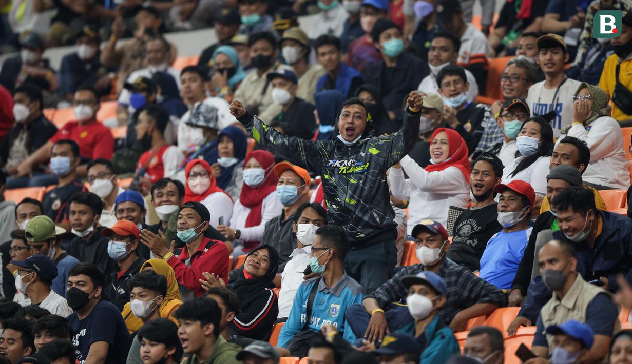 Seorang penonton menerikkan dukungan saat laga International Youth Championship 2021 antara Indonesia All Stars U-20 melawan Barcelona U-18 di Jakarta International Stadium, Jakarta, Rabu (13/04/2022). (Bola.com/Bagaskara Lazuardi)