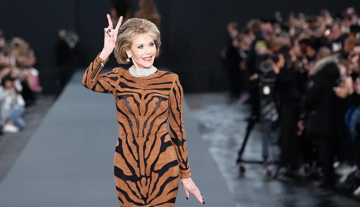 Aktris legendaris, Jane Fonda menunjukkan salam damai (dua jari) saat menjadi model fashion show untuk L'Oreal di Paris Fashion Week, Minggu (1/10). Jane Fonda tampil memukau  hingga tak ada yang menyangka bahwa usianya 79 tahun (AP Photo/Kamil Zihnioglu)