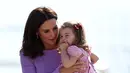 Kate Middleton menggendong sambil menghibur anaknya, Putri Charlotte, saat mengunjungi Pabrik Airbus di Hamburg, 21 Juli 2017. Putri Charlotte mendadak merajuk dan enggan naik helikopter di pabrik pesawat terbang itu. (Christian Charisius / POOL / AFP)