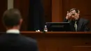 Aktor Johnny Depp bersaksi pada persidangan pencemaran nama baik di Fairfax County Circuit Courthouse, Fairfax, Virginia, Amerika Serikat, 19 April 2022. Johnny Depp menggugat Amber Heard setelah dia menulis artikel opini di The Washington Post pada tahun 2018. (JIM WATSON/POOL/AFP)