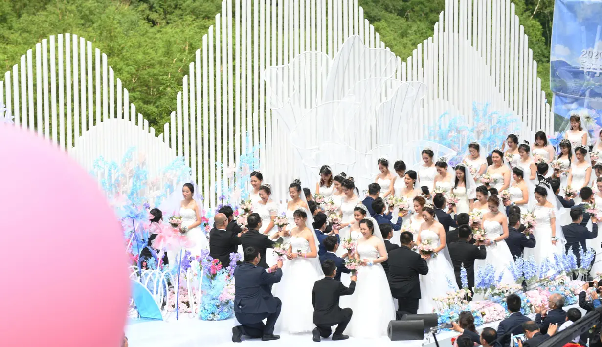 Para pasangan yang bergabung dalam perjuangan melawan COVID-19 mengikuti nikah massal di Provinsi Jilin, China, Rabu (8/7/2020). Nikah massal ini dihelat untuk 50 pasangan dari seluruh China yang telah berjuang melawan COVID-19 dan menunda pernikahan mereka. (Xinhua/Lin Hong)