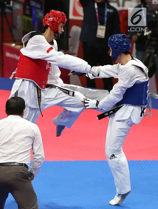 Atlet taekwondo Indonesia, Ibrahim Zarman bertarung melawan Gangmin Cho asal Korea Selatan di kelas putra under 63 Kg di lapangan taekwondo JCC, Jakarta, Rabu (22/8). Ibrahim gagal melaju ke semifinal. (Liputan6.com/Fery Pradolo)
