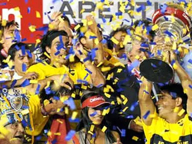 Boca Juniors' Hugo Ibarra holds up the trophy after obtaining the Argentina's league Championship at Presidente Juan Domingo Peron Stadium in Avellaneda, Buenos Aires, December 23, 2008. AFP PHOTO/Alejandro PAGNI 