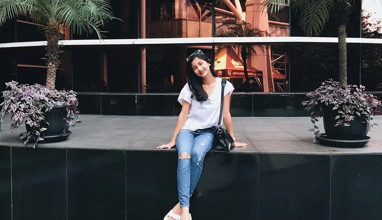 Saat di ruang publik, Faye Nicole terlihat begitu santai dengan duduk. Gaya santainya ini tetap terlihat menawan meski hanya memakai kaus warna putih dan celana 
jeans. (Liputan6.com/IG/@fayenicolee_)