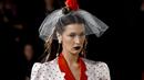 Bella Hadid berjalan di catwalk untuk show Rodarte pada New York Fashion Week: The Shows di New York City, Selasa (11/2/2020). Bella Hadid seolah-olah kembali ke era tahun 50an dalam balutan gaun polkadot merah dan putih dengan kerudung yang menutupi wajahnya. (Dimitrios Kambouris/Getty Images/AFP)
