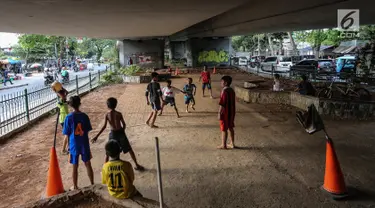 Anak-anak bermain sepak bola di kolong jembatan layang Tanah Abang, Jakarta, Kamis (15/11). Mereka memanfaatkan lahan kosong usai jam pulang sekolah. (Liputan6.com/Fery Pradolo)