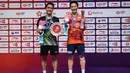 Tunggal putra Indonesia, Anthony Ginting, naik podium bersama tunggal Jepang, Kento Momota, pada BWF World Tour 2019 di Tianhe Gymnasium, Guangzhou, Minggu (15/12). Ginting kalah 21-17, 17-21 dan 14-21 dari Momota. (AFP/STR)