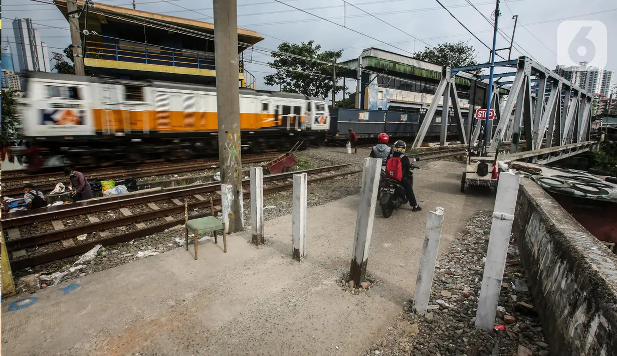 Kendaraan roda dua tetap melintas walaupun sudah ditutup di perlintasan kereta api di kawasan Tanah Abang-Palmerah Jakarta, Jumat (24/6/2022). PT Kereta Api Indonesia (Persero) atau KAI Daop 1 Jakarta menutup enam perlintasan liar sebagai upaya mewujudkan keselamatan dan keamanan perjalanan KA serta masyarakat.  (Liputan6.com/Faizal Fanani)