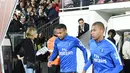 Penyerang PSG, Kylian Mbappe dan Neymar memasuki lapangan bersiap bertanding melawan Metz pada laga lanjutan Ligue 1 di stadion Longeville-les-Metz, Prancis (8/9). PSG menang 5-1 atas Metz. (AFP Photo/Patrick Hertzog)