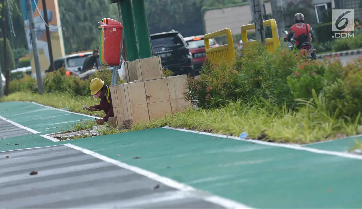 Pekerja melakukan pengerjaan tahap akhir renovasi trotoar di sekitar Jalan Gerbang Pemuda, Senayan, Jakarta, Selasa (29/5). Penataan trotoar menjadi prioritasmengingat Asian Games tinggal beberapa bulan ke depan. (Liputan6.com/Helmi Fithriansyah)