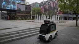 Robot otonom melintasi pusat perbelanjaan yang sepi saat sebagian besar toko diperintahkan tutup sebagai bagian dari pengendalian COVID-19 di Beijing, Senin (13/6/2022). Pengujian massal akan berlangsung antara Senin hingga Rabu di distrik Chaoyang, tempat bar itu berada, menurut para pejabat dalam konferensi pers. (AP Photo/Andy Wong)