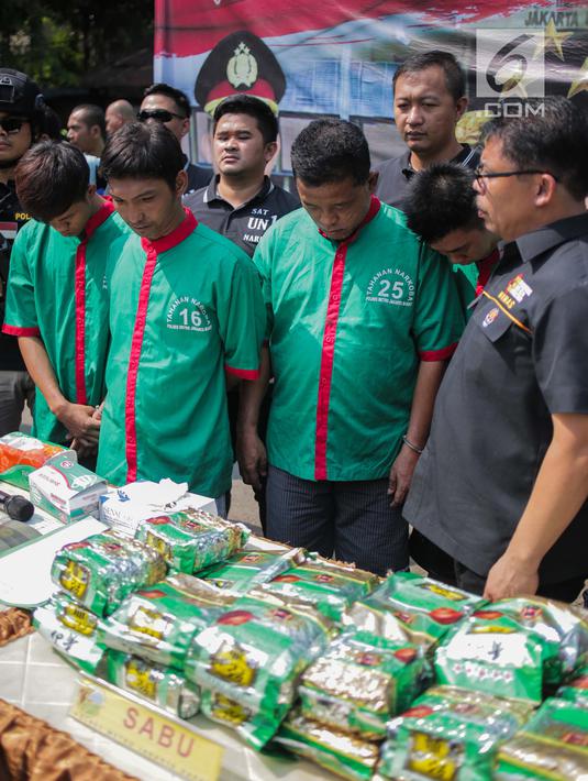 Empat tersangka dihadirkan saat rilis kasus pengungkapan narkotika jaringan Internasional Malaysia-Indonesia di Polres Jakarta Barat, Selasa (16/7/2019). Sejumlah barang barang bukti diantaranya 30 paket besar jenis sabu denga berat Brutto 30.000 Gram berhasil diamankan. (Liputan6.com/Faizal Fanani)