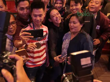 Kevin Sanjaya mengikuti foto elfie bersama fans dan wartawan di Galeri Indonesia Kaya, Grand Indonesia, Jakarta (28/3/2018). Kevin menerima deposito sebesar Rp 200 juta. (Bola.com/Nick Hanoatubun)