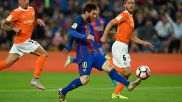 Penyerang Barcelona, Lionel Messi membawa bola saat pertandingan liga Spanyol antara Barcelona vs Osasuna di stadion Camp Nou, Barcelona (26/4). Dalam pertandingan itu Barcelona berhasil mengalahkan Osasuna dengan skor 7-1. (AFP/Lluis Gene)