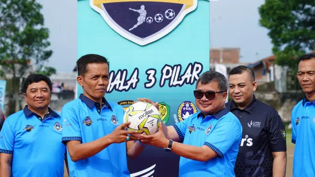 Bupati Garut Rudy Gunawan di apit Ketua Koni Garut Abdusy Syakur Amin, serta Ketua Asosiasi Kabupaten (Askab) PSSI Garut, Amirrudin Latief dalam pembukaan liga Desa Garut beberapa waktu lalu. (Liputan6.com/Jayadi Supriadin)