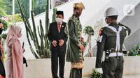 Presiden Joko Widodo atau Jokowi (kedua kanan) beserta Ibu Iriana Joko Widodo (kiri) tiba di Gedung Nusantara MPR/DPR/DPD RI, Jakarta, Selasa (16/8/2022). Presiden Jokowi akan menyampaikan pidato kenegaraan di Gedung MPR/DPR/DPD RI. (Liputan6.com/Angga Yuniar)
