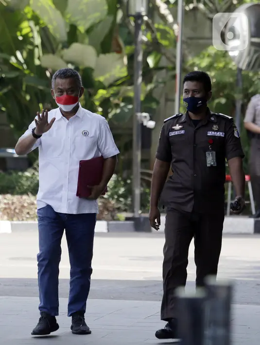 Ketua DPRD DKI Jakarta Prasetyo Edi Marsudi (kiri) melambaikan tangan saat tiba di halaman Gedung Komisi Pemberantasan Korupsi (KPK), Jakarta, Selasa (21/9/2021). Prasetyo akan menjalani pemeriksaan dalam kasus dugaan korupsi pengadaan lahan di Munjul pada tahun 2019. (Liputan6.com/Angga Yuniar)