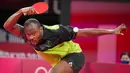 Petenis Nigeria, Quadri Aruna, berusaha mengembalikan bola saat bertanding melawan atlet tenis meja Brasil, Gustavo Tsuboi, pada pertandingan putaran ketiga di Olimpiade Tokyo 2020, Selasa, (27/7/2021). (Foto: AP/Kin Cheung)