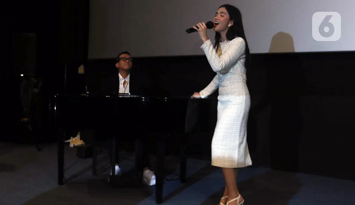 Penyanyi Lyodra Ginting (kanan) bernyanyi diiringi musikus sekaligus komposer Andi Rianto saat konferensi pers peluncuran remake lagu 'Sang Dewi' di kawasan Thamrin, Jakarta, Kamis (11/8/2022). Lyodra Ginting secara resmi meluncurkan remake lagu lawas dan musik video 'Sang Dewi' yang berkolaborasi dengan Andi Rianto. (Liputan6.com/Herman Zakharia)