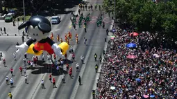 Di sepanjang jalan, warga antusias meyambut meriah parade beragam balon karakter kartun fiksi dan film animasi. (RODRIGO ARANGUA/AFP)
