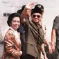 Presiden BJ Habibie didampingi istrinya Ainun Habibie melambaikan tangan kepada wartawan saat tiba di pusat perbelanjaan yang hancur akibat gelombang kekerasan di Chinatown, Jakarta, 26 Mei 1998. Habibie meninggal pada usia 83 tahun akibat gagal jantung dan menua. (AFP Photo/Kemal Jufri)