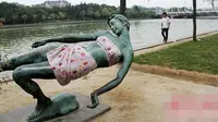 Sebuah patung besar dengan pose seperti terjatuh memang selalu menjadi sorotan pengunjung di kawasan Zhengzhou, provinsi Henan, China.