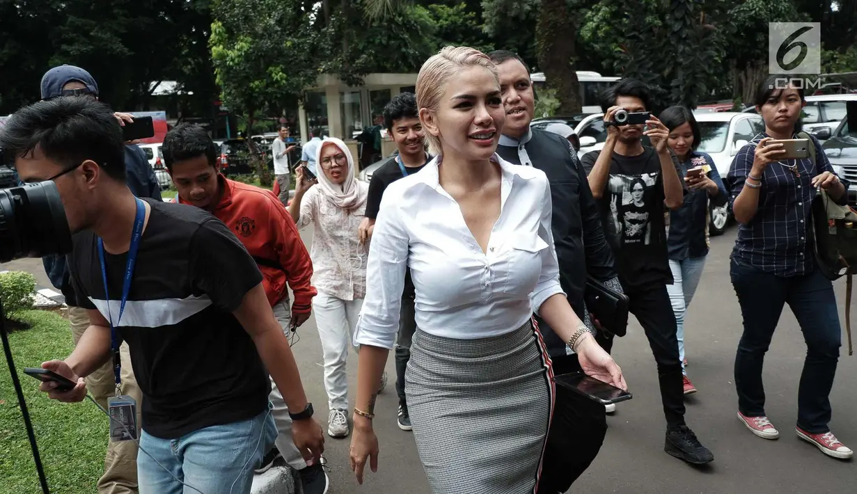 Nikita Mirzani tiba memenuhi panggilan Ditreskrimsus Unit Cyber Polda Metro Jaya, Jakarta, Senin (26/2). Artis seksi ini tampil dengan baju putih ketat dengan rambut berwarna pirang. (Liputan6.com/Faizal Fanani)