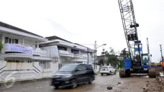Kendaraan melintas di dekat spanduk penolakan terhadap rencana pembangunan jalan tol di kawasan perumahan Pluit, Jakarta, Kamis (17/12). Penolakan akibat rencana pembangunan jalan layang non tol yang masuk ke pemukiman mereka. (Liputan6.com/Faisal R Syam)