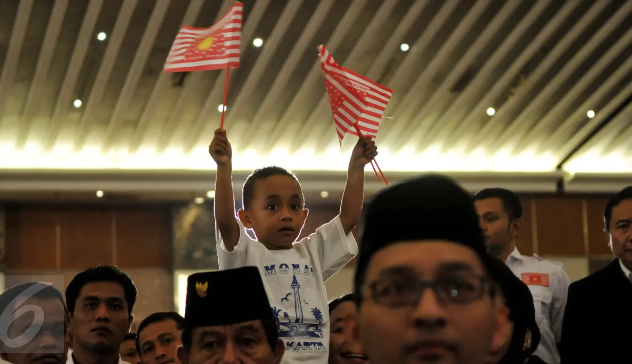 Seorang anak melambaikan bendera Partai Priboemi saat deklarasi Partai Priboemi di Jakarta, Senin (17/8/2015). Tepat di Hari Kemerdekaan, partai yang berlogo simbol Kerajaan Majapahit itu mendeklarasikan sebagai partai baru. (Liputan6.com/Johan Tallo)