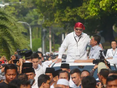 Ketua umum Partai Gerindra Prabowo Subianto mengenakan bandana merah menyapa para pendukungnya usai mendaftarkan bakal calon pasangan Presiden dan wakil presiden di Komisi Pemilihan Umum (KPU), Jakarta, Jumat (10/8).(Merdeka.com/Imam Buhori)
