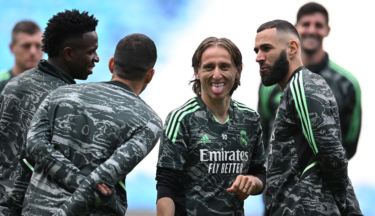 Pemain Real Madrid, Luka Modric (kedua kiri) bercanda dengan rekannya saat melakukan latihan menjelang laga semifinal Liga Champions 2022/2023 melawan Manchester City di Etihad Stadium, Manchester, Selasa (16/05/2023) waktu setempat. (AFP/Oli Scarff)