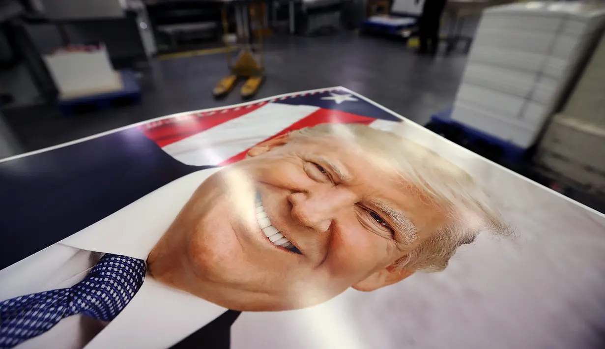 Ratusan foto resmi presiden Amerika Serikat Donald Trump yang akan dikemas dan diedarkan, Washington DC (4/12). Ribuan foto resmi Donald Trump ini akan diedarkan ke lebih 1.600 kantor federal di seluruh dunia. (Chip Somodevilla/Getty Images/AFP)