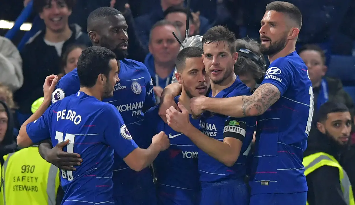 Penyerang Chelsea , Eden Hazard (tengah) berselebrasi dengan rekan setimnya setelah mencetak gol ke gawang West Ham United dalam lanjutan Liga Inggris 2018/2019 di Stadion Stamford Bridge, Senin (8/4). Eden Hazard membantu Chelsea menang 2-0 atas West Ham United. (OLLY GREENWOOD / AFP)