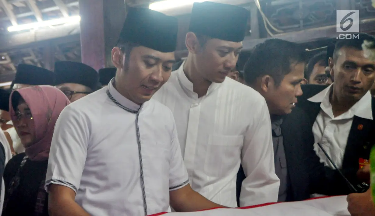 Anak presiden ke-6 RI Susilo Bambang Yudhoyono, Agus Harimurti Yudhoyono dan Edhie Baskoro Yudhoyono menangis di dekat peti jenazah Ani Yudhoyono di Puri Cikeas, Bogor, Jawa Barat, Minggu (2/6/2019). (Liputan6.com/Immanuel Antonius)