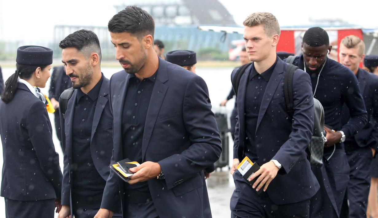 Pemain Jerman, Sami Khedira dan Ilkay Gundogan berdiskusi saat tiba di Moskow, Selasa (12/6/2018). Jerman datang ke Rusia untuk mempertahankan gelar juara Piala Dunia. (AFP/Daniel Roland)