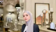 Lesti Kejora mengenakan blazer hitam senada dengan celana panjangnya. Dipadukan inner t shirt putih dan kerudung panjang abu-abu. [@lestikejora]