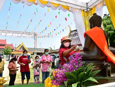 Umat Buddha menghadiri doa saat mereka merayakan Tahun Baru Buddha, yang secara lokal dikenal sebagai Songkran, di kuil Prachapirom di Narathiwat (12/4/2022). (AFP/Madaree Tohlala)