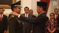 Presiden Joko Widodo menyematkan pangkat ke bahu Letjen Andika Perkasa saat pelantikan Kepala Staf TNI Angkatan Darat (KSAD) di Istana Kepresidenan, Kamis (22/11). Andika menggantikan Jenderal TNI Mulyono yang akan pensiun. (Liputan6.com/Angga Yuniar)