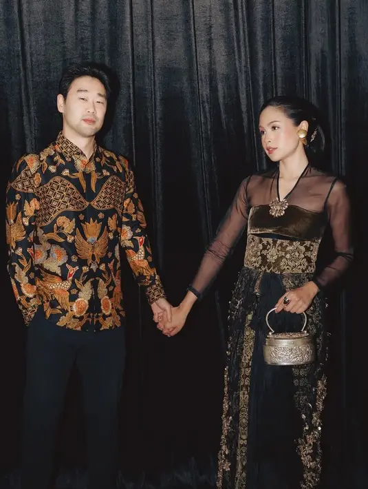 <p>Maudy juga bawa tas unik model perak. Ia hadir bersama suaminya yang mengenakan kemeja batik lengan panjang. [@maudyayunda]</p>