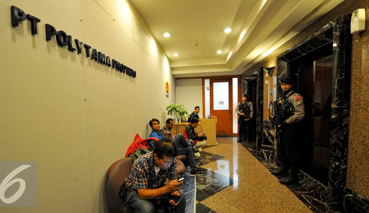 Petugas kepolisian berjaga di depan lift kantor PT.Polytama propindo di Jakarta, Kamis (18/6/2015). Penyidik menggeledah kantor pendiri TPPI Honggo Wendratmo terkait korupsi penjualan kondensat dari SKK Migas kepada PT TPPI. (Liputan6.com/Yoppy Renato)