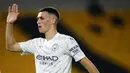 Pemain Manchester City, Phil Foden, melakukan selebrasi usai mencetak gol ke gawang Wolverhampton Wanderers pada laga Liga Inggris di Stadion Molineux, Senin (21/9/2020). Manchester City menang dengan skor 3-1. (Stu Forster/Pool via AP)