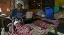 Seorang pekerja membungkus kembang api dengan plastik sebelum dikirim ke toko di kota Bocaue, provinsi Bulacan, Filipina, (26/12/2015). (REUTERS/Romeo Ranoco)