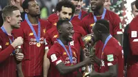 Penyerang Liverpool, Sadio Mane mencium trofi Piala Dunia Antarklub 2019 setelah mengalahkan Flamengo di Stadion Internasional Khalifa di Doha, Qatar (22/12/2019). Liverpool menang 1-0 atas Flamengo berkat gol tunggal Roberto Firmino di menit ke-99. (AP Photo/Hassan Ammar)