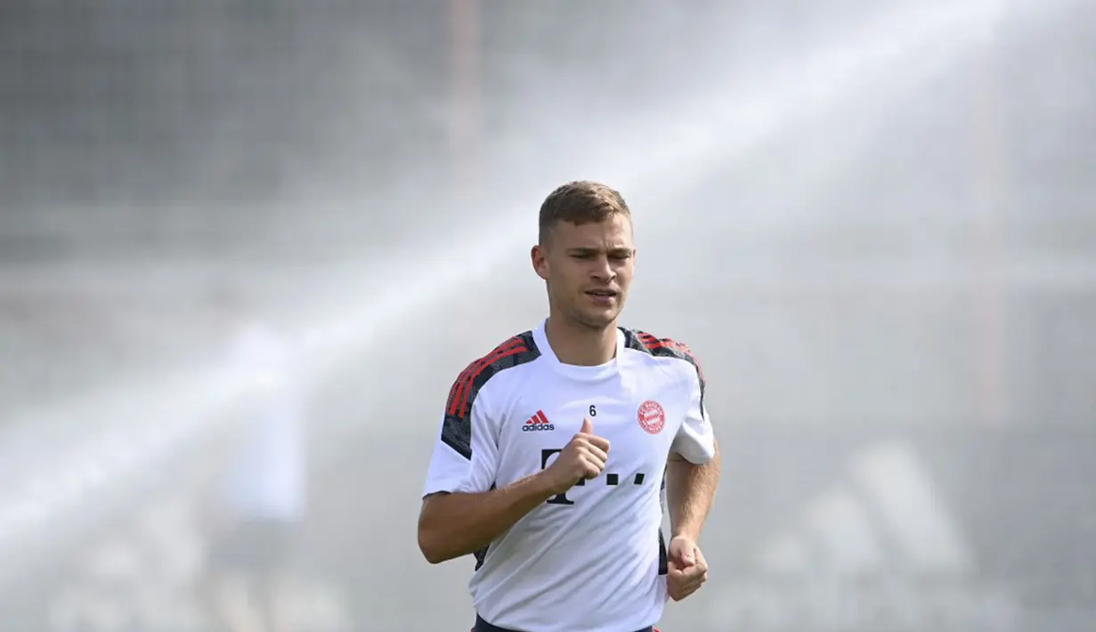 Pemain Bayern Munchen Joshua Kimmich melakukan pemanasan saat sesi latihan di tempat latihan klub di Munchen, Jerman, 13 September 2021. Bayern Munchen akan menghadapi Barcelona pada pertandingan Grup E Liga Champions. (CHRISTOF STACHE/AFP)