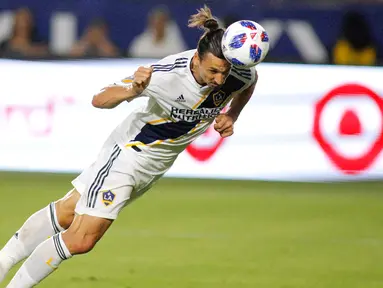 Penyerang LA Galaxy, Zlatan Ibrahimovic saat menyundul bola ke arah gawang kiper Orlando City, Earl Edwards Jr pada pertandingan MLS di StubHub Center di Carson, California (29/7). LA Galaxy menang tipis 4-3 atas Orlando City. (AFP Photo/Katharine Lotze)