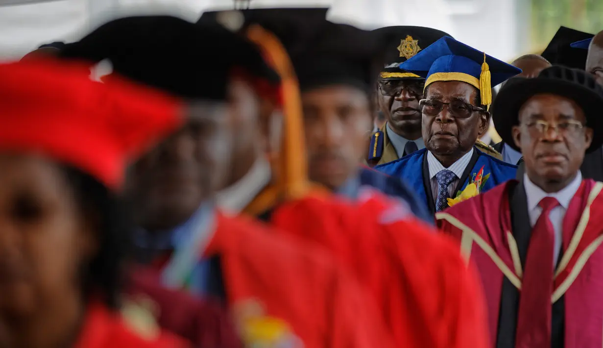Presiden Zimbabwe, Robert Mugabe menghadiri upacara wisuda mahasiswa Universitas Terbuka Zimbabwe di pinggiran Harare, Jumat (17/11). Kemunculan Mugabe juga memastikan pernyataan militer bahwa Mugabe dan keluarganya tidak disakiti. (AP Photo/Ben Curtis)